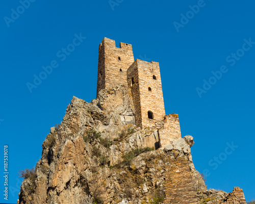 old Ruined Military Tower of Vovnushki in Ingushetia, Russia blue background sky photo