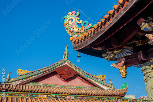 The decoration with cut-and-paste porcelain on the roof of Mahavira Hall in Kaiyuan Temple in ChaoZhou China. 
These vibrant artworks showcase the intricate craftsmanship of Chaoshan. photo