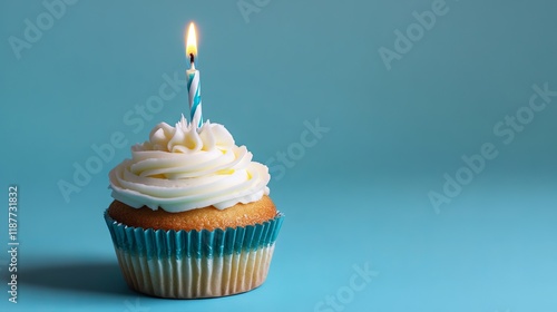 Delicious cupcake with colorful birthday candle on a bright blue background, perfect for celebrations and party themes photo