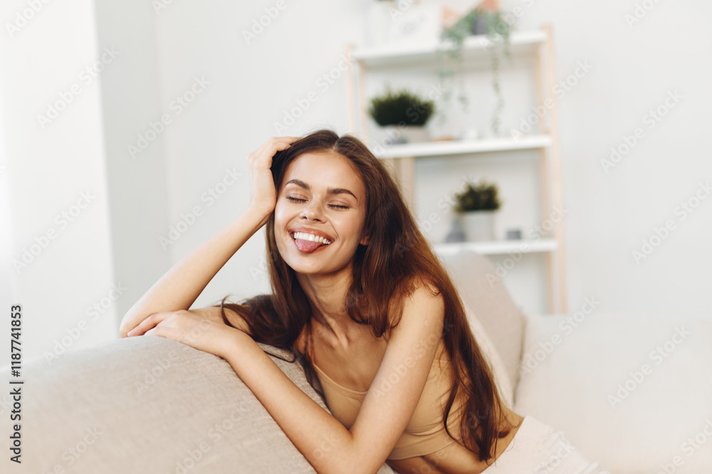 Cozy Sofa, Happy Woman: Smiling and Confident on White Wool Couch in Modern Apartment Cozy Sofa, Happy Woman: Smiling and Confident on White Wool Couch in Modern Apartment