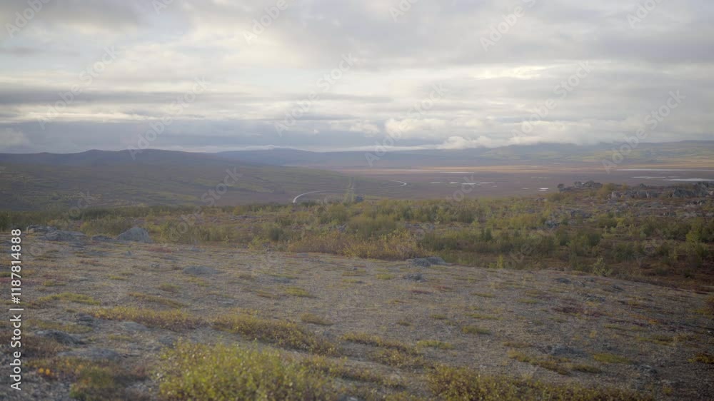 A Distant Road Snakes Through Open, Untamed Wilderness Surrounded By Expansive Fields And Gentle Hills - Fairbanks, Alaska A Distant Road Snakes Through Open, Untamed Wilderness Surrounded By Expansive Fields And Gentle Hills - Fairbanks, Alaska