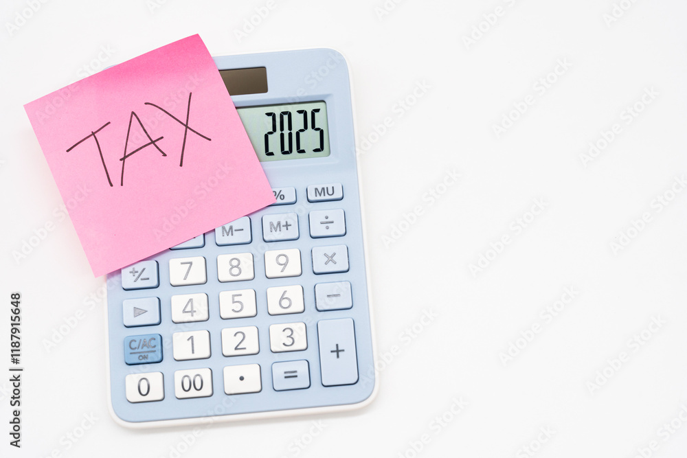 Tax Sticky note on calculator, forecast for finances in 2025. Budget, tax, investment, financial, savings. calculator with 2025 numbers. Tax Sticky note on calculator, forecast for finances in 2025. Budget, tax, investment, financial, savings. calculator with 2025 numbers.