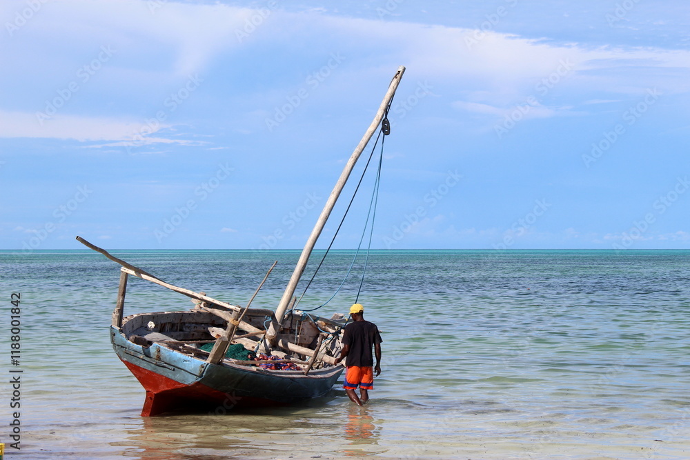Zanzibar fisherman checking on his boat while beautiful weather conditions. Zanzibar fisherman checking on his boat while beautiful weather conditions.