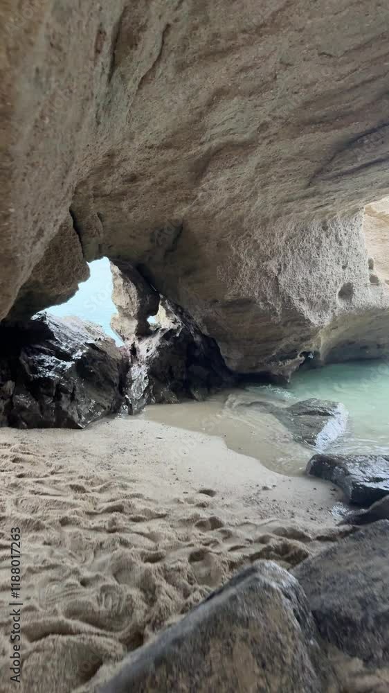 The ocean is calm and the sky is cloudy. The sun is setting and the water is reflecting the colors of the sky