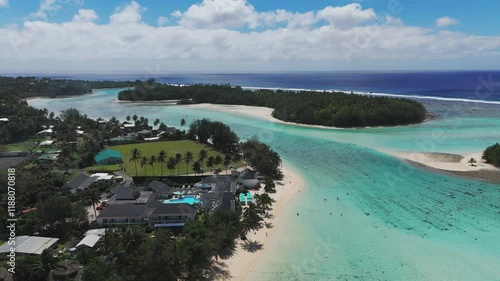 Breathtaking aerial dolly forward shot over Muri Beach, Rarotonga, showcasing a turquoise lagoon, small islands, and a palm-lined sandy beach. Perfect for tropical and travel footage. photo