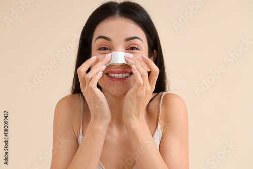 Young woman applying nose p...