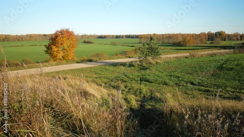 A cycling tourist cyclist riding on a country road in autumn