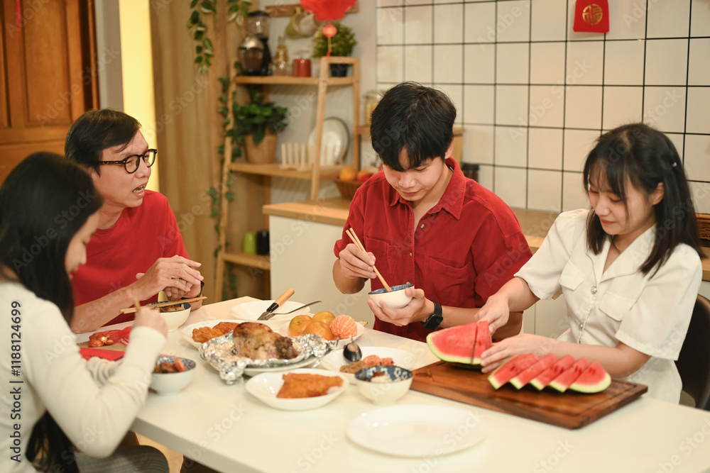 Multi generational family savoring a festive meal together during Chinese New Year reunion dinner Multi generational family savoring a festive meal together during Chinese New Year reunion dinner