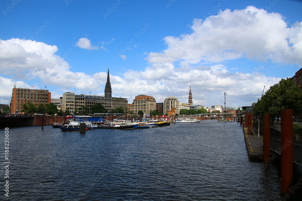 Fototapeta premium View of the Alster estuary with the Saint Nikolai memorial and the main church St. Katharinen in the background, Hamburg 