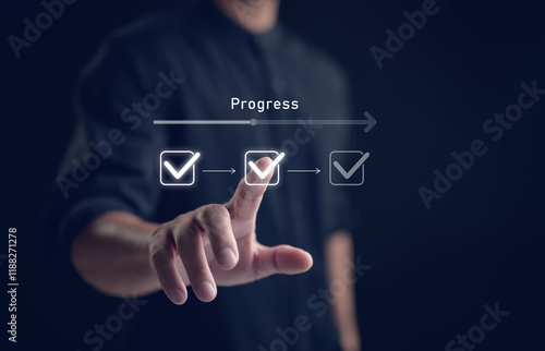 Businessman touching to tick correct mark in checklist with progressive loading status to remind work task progressive for project develop management and tracking concept. photo