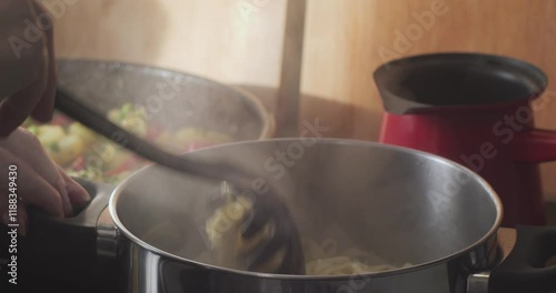 Preparing pasta in steaming metal pan 4K video