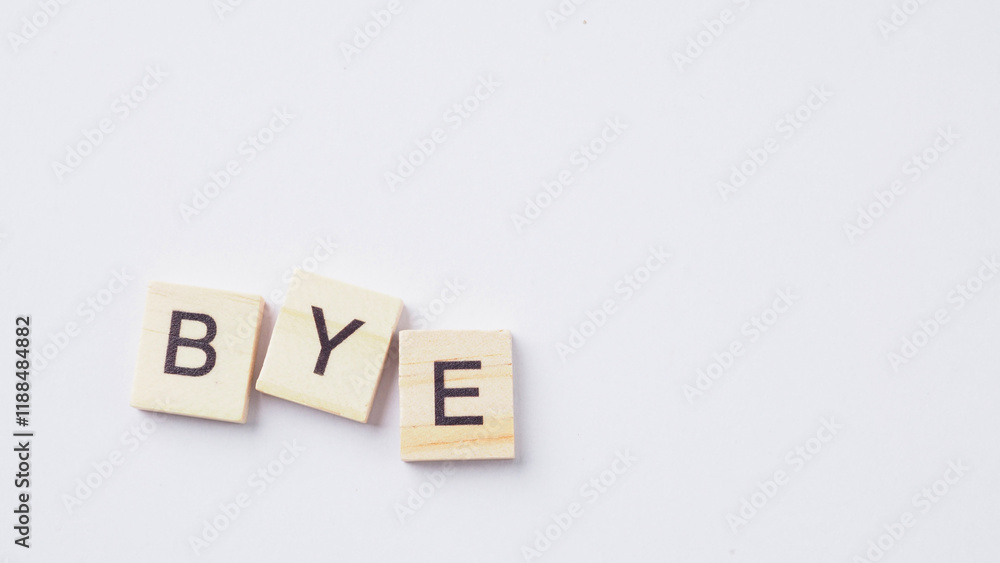 The word Bye from wooden cube letters on a white background. The word Bye from wooden cube letters on a white background.