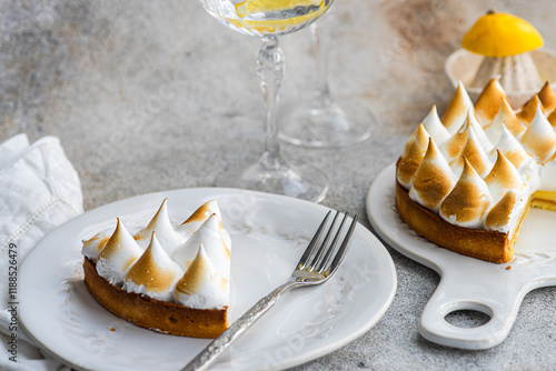 Overhead view of a Homemade lemon meringue tart with lemon water drinks photo