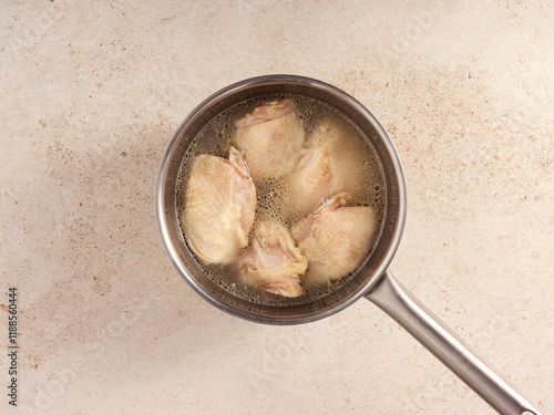 Cooking a Spanish Chicken Broth With Tender Pieces Simmering Gently in a Pot on a Clean Countertop photo