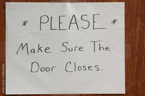 Handwritten sign on door Please Make Sure the Door Closes photo