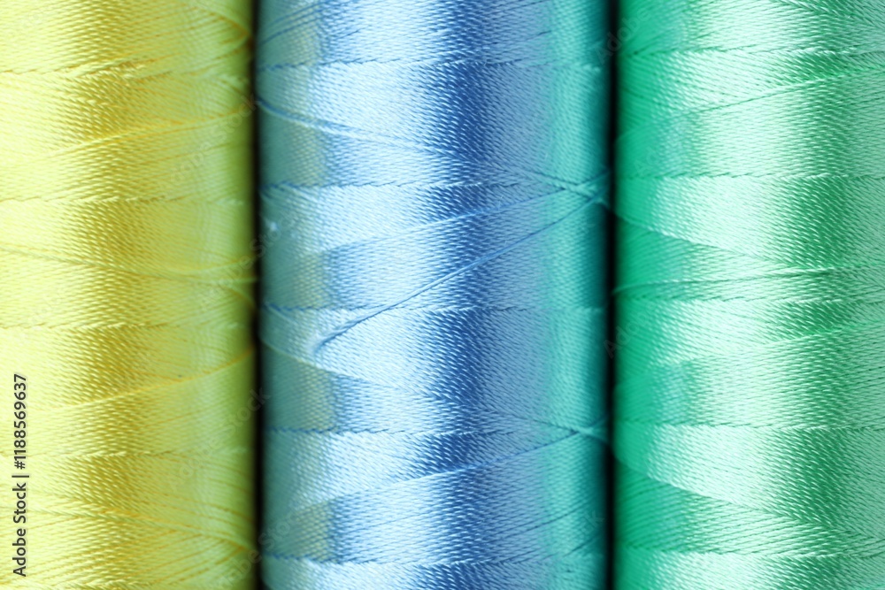 Spools of colorful sewing threads as background, top view Spools of colorful sewing threads as background, top view