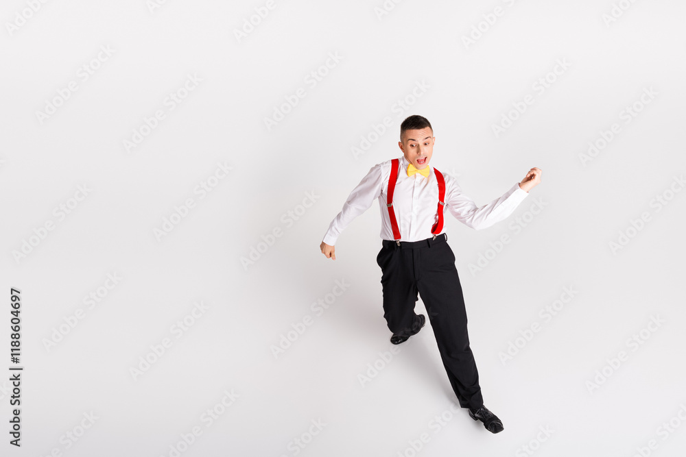 Young and energetic man dancing with style, showcasing ballroom moves in black pants and a white shirt against a pristine white background Young and energetic man dancing with style, showcasing ballroom moves in black pants and a white shirt against a pristine white background