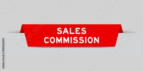 Red color inserted label with word sales commission on gray background