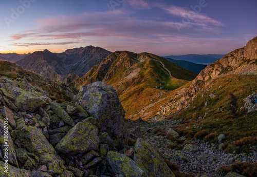 Mountain trail leading along the mountain ridge of beautiful mountains with autumn grass and colorful sky. High Tatras, Slovak, Poland. Mountains Nature in Golden Morning Landscape, outdoor adventure photo