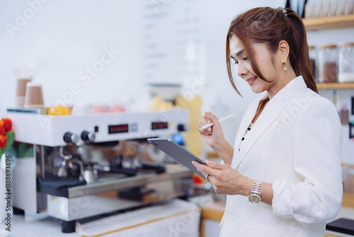 A driven Female Executive spent her morning in the cafe, drafting a business pitch for an investment partnership aimed at entering the competitive international market... photo