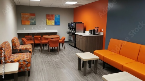 Modern office breakroom with orange furniture, coffee station, and seating area.