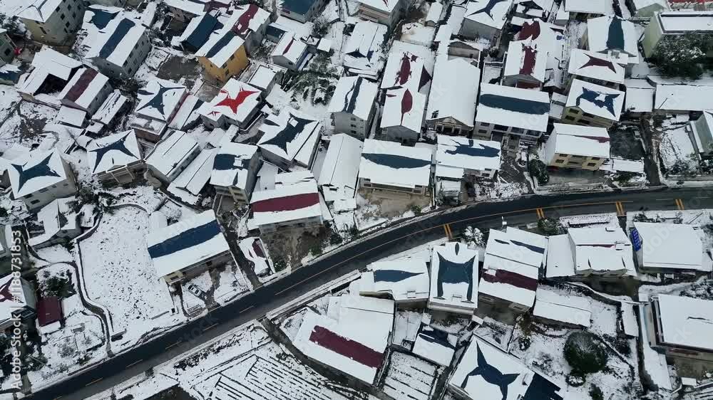 Winter wonderland scene with cars navigating snowy countryside roads