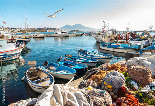 Obraz na płótnie GenFishing boats at the pier in the port of Naples on a sunny day with Mount Vesuvei in the background
erated image w salonie