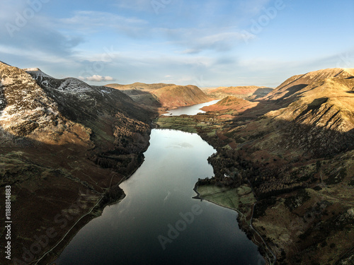 Dramatic aerial drone landscape in Autumn Winter of snowcapped mountains around Buttermere in Lake District at sunrise photo