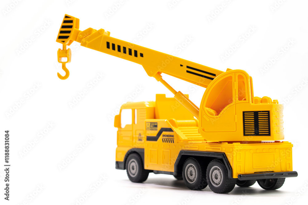 Naklejka premium toy truck crane isolated on white background. Construction industrial equipment for transporting materials. Plastic child toy on white backdrop. Construction vehicle. Children's toy. Crane Toy.