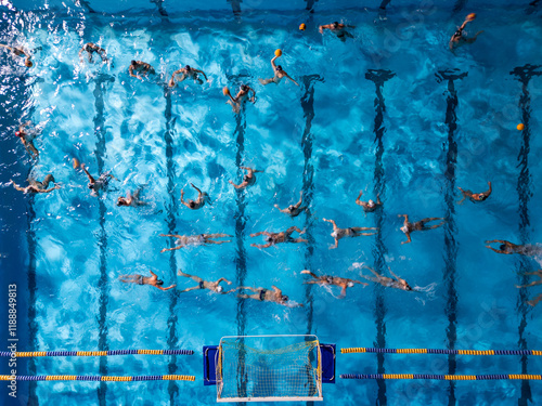 Aerial view of a water polo match in a blue swimming pool, players actively competing under bright lights photo