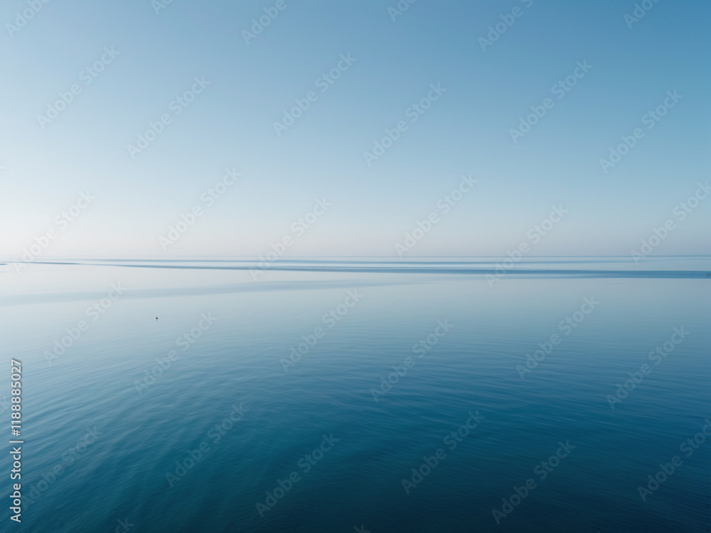 A serene photograph of a vast ocean with a calm, blue sky above. A serene photograph of a vast ocean with a calm, blue sky above.