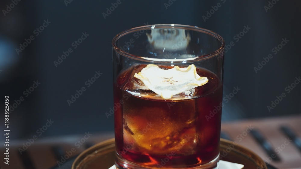 Closeup cocktail whiskey in Old fashioned with cube ice decorated dried sliced apple on top making special drink list, advertisement focusing alcohol refreshing showcase copy space at club. Vinosity. Closeup cocktail whiskey in Old fashioned with cube ice decorated dried sliced apple on top making special drink list, advertisement focusing alcohol refreshing showcase copy space at club. Vinosity.