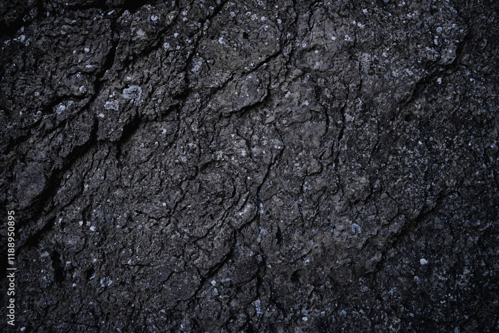 Fototapeta premium Dark stone texture background. Close up of limestone rock wall. Clay surface with cracks. Modern dark gray grunge background with space for design. Granite. Slab. Nature Backdrop. Wallpaper.