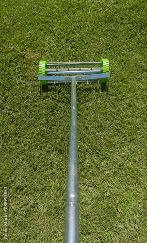 Rolling lawn aerator lawn in action photo