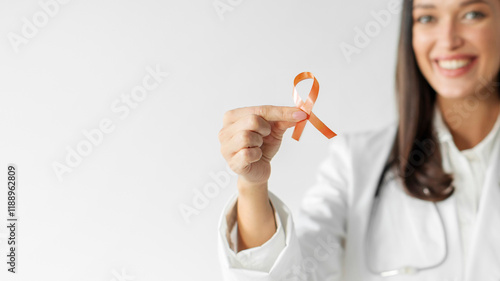 Leukemia, Kidney cancer day, world Multiple Sclerosis, CRPS, Self Injury Awareness. Doctor holding orange ribbon for supporting people living and illness, free space photo