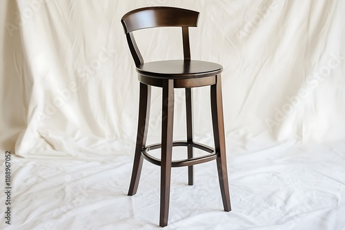 Classic wooden bar stool with a curved back and dark finish, set against a white backdrop photo