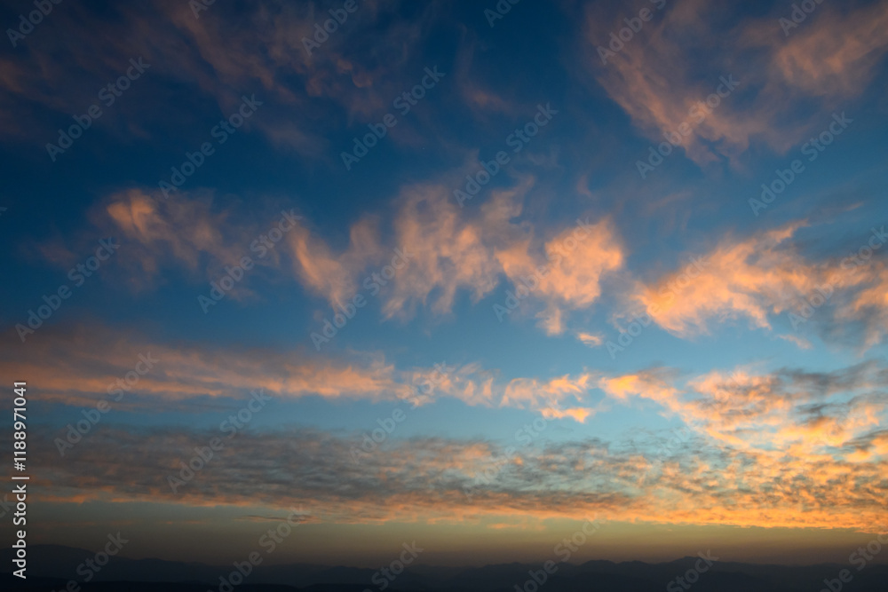 Whispers of twilight as clouds dance across a vibrant evening sky Whispers of twilight as clouds dance across a vibrant evening sky