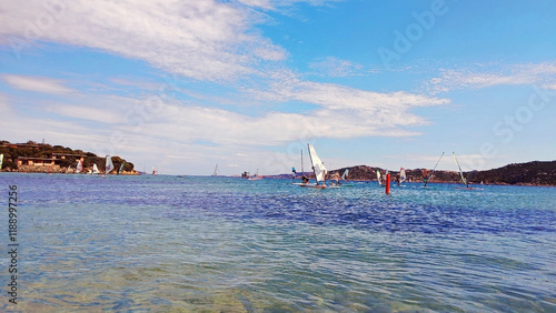 Windsurfers sailboarding in the crystal-clear sea of Porto Pollo. Porto Puddu, Palau, Sassari, Sardinia Island, (Sardegna), Italy. photo