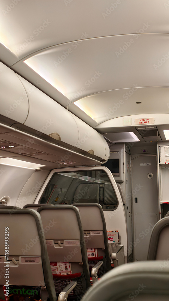 Obraz premium Modern Airplane Cabin Interior with Overhead Compartments and Passenger Seating
