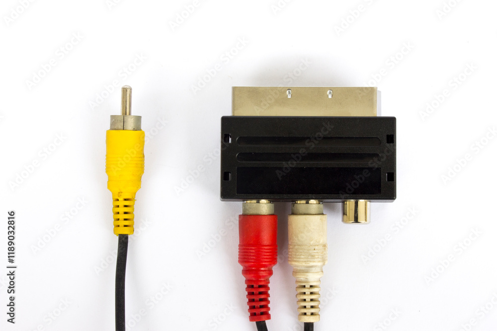 Audio-video adapter with plugs on dark background. Audio-video adapter with plugs on dark background.