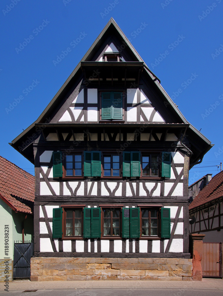 Half-timbered wooden residential house with symmetrical gable in the old town of Kandel, Rheinland-Pfalz in Germany Half-timbered wooden residential house with symmetrical gable in the old town of Kandel, Rheinland-Pfalz in Germany