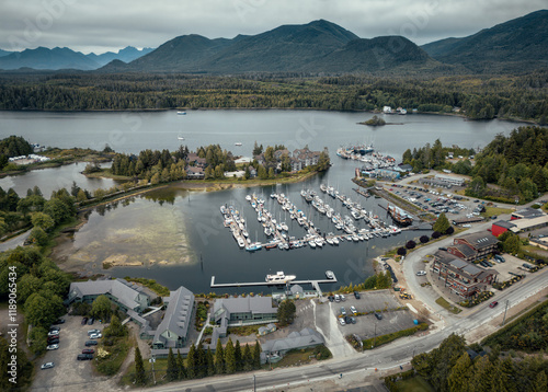 Ucluelet, British Columbia, Canada. Aerial view of Ucluelet harbour on the West Coast of Vancouver Island. Town center with marina, holiday apartments on the sea bay with mountains in background.  photo