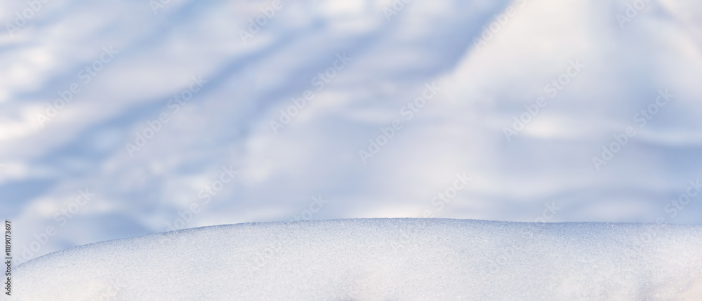 Winter christmas background, banner - view of the snowdrift sparkling in the rays of the winter sun, selective focus