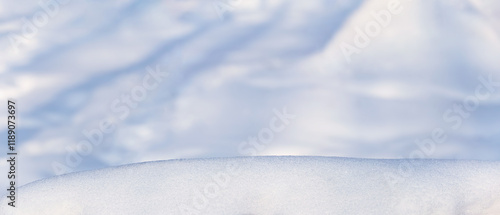 Obraz na płótnie Winter christmas background, banner - view of the snowdrift sparkling in the rays of the winter sun, selective focus w salonie