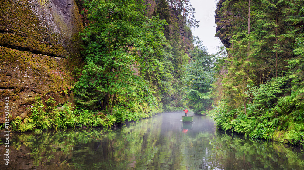Summer natural landscape - view of the river with a boatman in the Elbe Sandstone Mountains, Bohemian Switzerland, the north-western Czech Republic