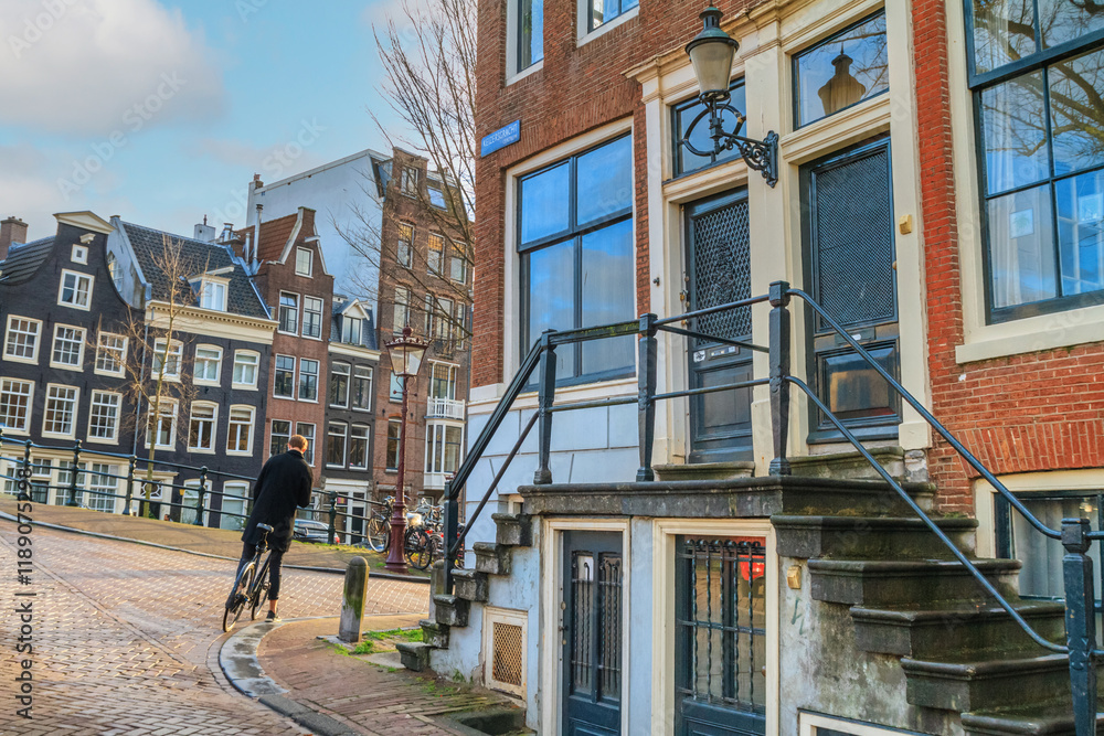Cityscape - view of the porch of the facade of a building with steps in the old district of the city of Amsterdam, the Netherlands