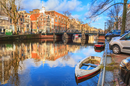 Cityscape on a sunny winter day - view of the canal and bridge in the historic center of Amsterdam, The Netherlands