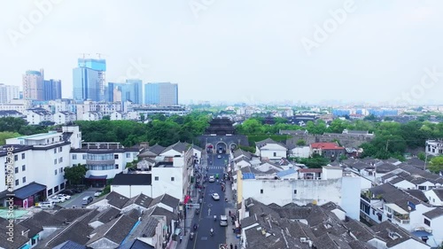 Experience the breathtaking aerial view of Changmen gate tower in Suzhou, showcasing ancient architecture amidst modern skyline photo