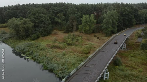 Quads driving over the bridge.