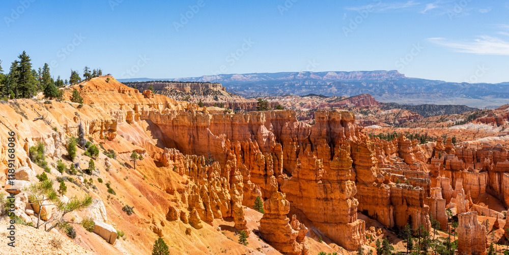 Majestic Hoodoos of Bryce Canyon: A Panoramic View of Nature's Sculpted Wonders in Vibrant Red and Orange Hues Against a Clear Blue Sky in Utah's Iconic National Park Majestic Hoodoos of Bryce Canyon: A Panoramic View of Nature's Sculpted Wonders in Vibrant Red and Orange Hues Against a Clear Blue Sky in Utah's Iconic National Park